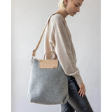 Graf Lantz Bedford Merino Wool Backpack in granite color, showing its soft wool texture and sleek design with shoulder straps.