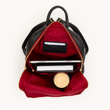 Hammitt Hunter backpack in black brushed leather with gold hardware and red zipper accents on a plain background.