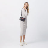 Hammitt Nash Small handbag in black brushed gold leather with red zipper details, featuring a compact design and gold hardware.