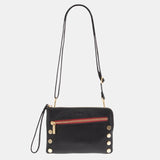 Hammitt Nash Small handbag in black brushed gold with red zipper, featuring sleek design and compact size.