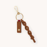 Hammitt cocoa gold knotted leather key ring with metal keychain attachment, stylish and durable accessory.