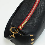 Black Hammitt Bryant Med crossbody bag with brushed gold hardware and red zipper, showcasing a stylish, compact design.