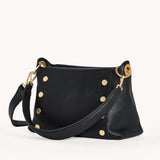 Black Hammitt Bryant Med crossbody bag with zip closure and adjustable strap, showcasing sleek leather design.