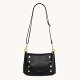 Hammitt Bryant Med crossbody bag in black leather with brushed gold hardware and red zipper, showcasing a stylish and functional design.
