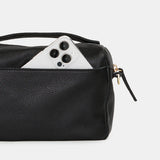 Black Hammitt Evan Crossbody Sml bag with brushed gold hardware and red zipper, compact and stylish crossbody bag for everyday use.