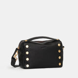 Black Hammitt Evan Crossbody Sml bag with brushed gold accents and red zipper, stylish compact crossbody bag for everyday use.