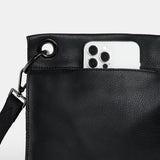 Black Hammitt Tony Med crossbody bag with sleek design and adjustable strap, featuring gold hardware and spacious interior.