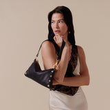 Black Hammitt Kyle Med handbag with brushed gold hardware and red zipper, featuring a sleek, stylish design.
