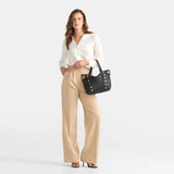 Black Hammitt Daniel Med purse with brushed gold hardware and red zipper, featuring a sleek, compact design and stylish leather finish.
