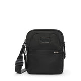 Tumi Alpha medium crossbody bag with adjustable strap and multiple compartments, shown in a sleek urban style.