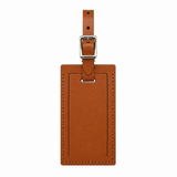 Personalized brown leather luggage tag with engraved name, featuring a clear ID window and sturdy strap from Index Urban.
