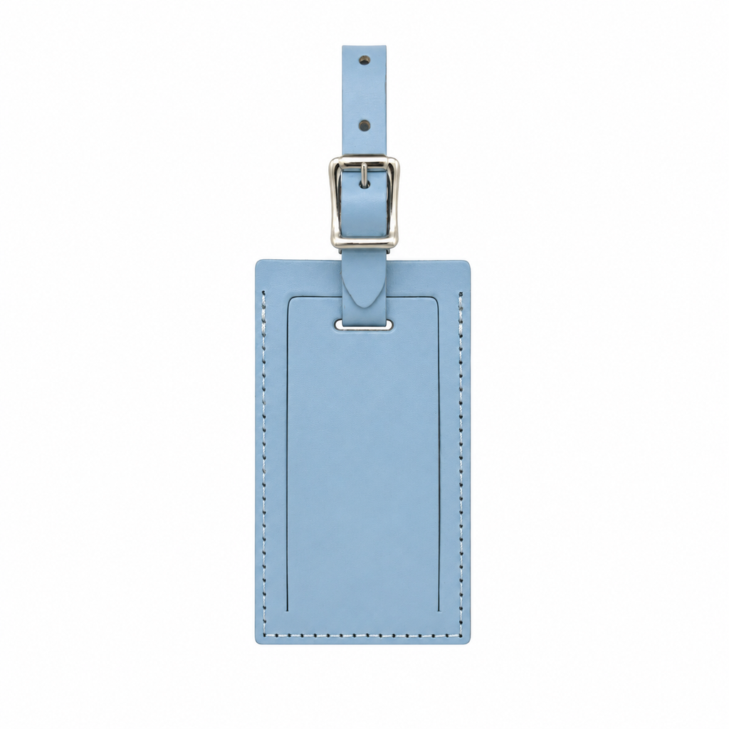 Personalized leather luggage tag from Index Urban with engraved details, made in the USA, attached to a suitcase handle.