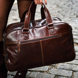 Jack Georges Classic Duffel Bag in brown leather with top handles and a spacious main compartment.