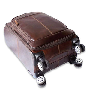 Brown Jack Georges Voyager Collection 22-inch upright wheeled carry-on luggage with sturdy handle and four spinner wheels.