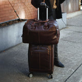Brown Jack Georges Voyager Collection 22-inch upright wheeled carry-on luggage with retractable handle and four spinner wheels.