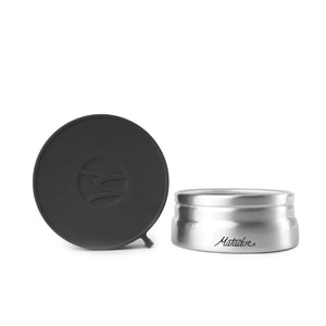 Open Matador waterproof travel canister 100ml accessory showing clear interior with secure lid on white background.