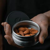 Matador waterproof travel canister, 100ml, compact accessories container for liquids, in black with secure screw cap.