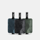 Three charcoal-colored Matador FlatPak™ toiletry bottles in a pack, compact and lightweight travel accessories for toiletries.