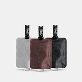 Set of three charcoal Matador FlatPak™ toiletry bottles, compact travel accessories for liquids and toiletries.