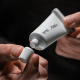 Matador refillable toothpaste tubes accessory in black and silver, designed for eco-friendly toothpaste storage.