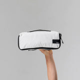 Set of three white Matador packing cubes with multiple compartments for organized travel storage.