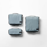 Set of three Matador packing cubes in slate color, organized for travel and storage, showcasing durable fabric and compact design.