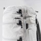 Matador SEG28 backpack in arctic white, featuring a sleek, compact design with multiple compartments and adjustable straps.