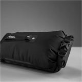 Black Matador Flatpak Dry Bag 2L shown with secure roll-top closure and compact design for waterproof storage.