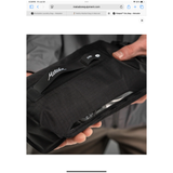 Black Matador Flatpak Dry Bag 2L shown with roll-top closure and compact design, ideal for waterproof storage during outdoor activities.