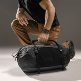 Matador Freefly 30L packable duffle bag made of durable material, shown in a compact, foldable form ready for travel.