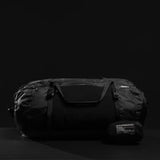 Matador Freefly 30L packable duffle bag in black, showing its compact, lightweight design with a zipper closure and carry handle