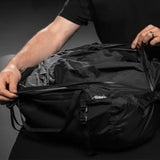 Matador Freefly 30L packable duffle bag in black, showcasing lightweight, compact design with sturdy handles and spacious interior.