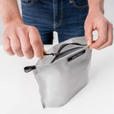 Matador Flatpak zipper toiletry case with compact design and black fabric, ideal for travel organization.