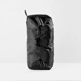 Black Matador packable laundry bag shown folded and expanded, featuring lightweight, durable design for easy laundry transport.