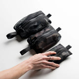 Set of black Mesh Organizer Bags by Matador for packing organization, featuring multiple compartments for travel essentials.