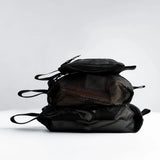 Set of black Matador mesh organizer bags for packing and travel organization, featuring multiple sizes for versatile storage.