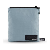 Slate blue Matador Nanodry packable towel poncho laid flat, showcasing its lightweight, quick-drying fabric and relaxed fit.