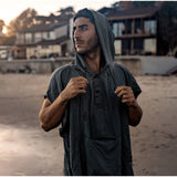 Matador Nanodry packable towel poncho in slate blue, lightweight, quick-drying fabric perfect for outdoor activities and travel.