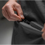 Matador Nanodry packable towel poncho in slate blue, lightweight and quick-drying for beach or outdoor use.