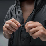 Slate blue Matador Nanodry packable towel poncho laid flat, showcasing its lightweight, quick-drying fabric and comfortable fit.