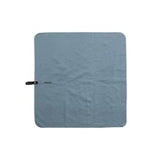 Slate blue Matador Nanodry Trek Towel spread out, showing its lightweight, quick-drying fabric designed for outdoor adventures.