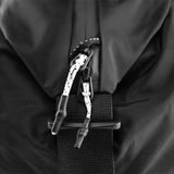 Matador Refraction packable duffle bag in black fabric, showing compact design and sturdy handles for travel and storage.