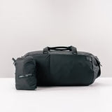 Matador Refraction packable duffle bag in durable fabric, shown partially folded with handles and zipper open for travel use