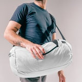 Matador Refraction packable duffle bag in durable fabric, shown folded and expanded, ideal for travel and outdoor activities.