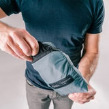Matador Refraction packable duffle bag in black, showing its compact, lightweight design and durable fabric for travel and storage.
