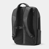 Black Nomatic Travel Pack 20L-30L with multiple compartments, shown from the back angle, designed for versatile travel and organization.