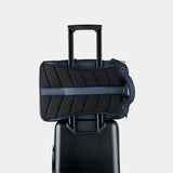 Navy Nomatic Travel Pack 14L-21L with sleek design, multiple compartments, and ergonomic straps for versatile travel storage