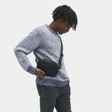 Black Nomatic Access Sling made of durable material, designed for compact carrying and easy access to essentials.