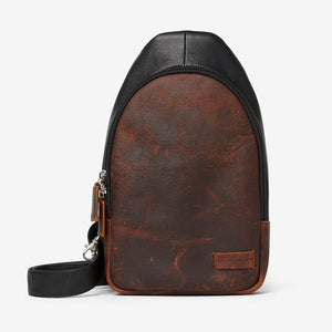 Black Osgoode Marley Cyrus sling bag with adjustable strap and front pocket, shown from the front view.