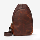 Osgoode Marley Cyrus sling bag in Brandy color with front pocket and adjustable strap, shown from the front view.